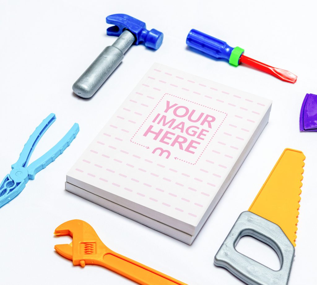 Two books on top of each other and around them are toy tools.