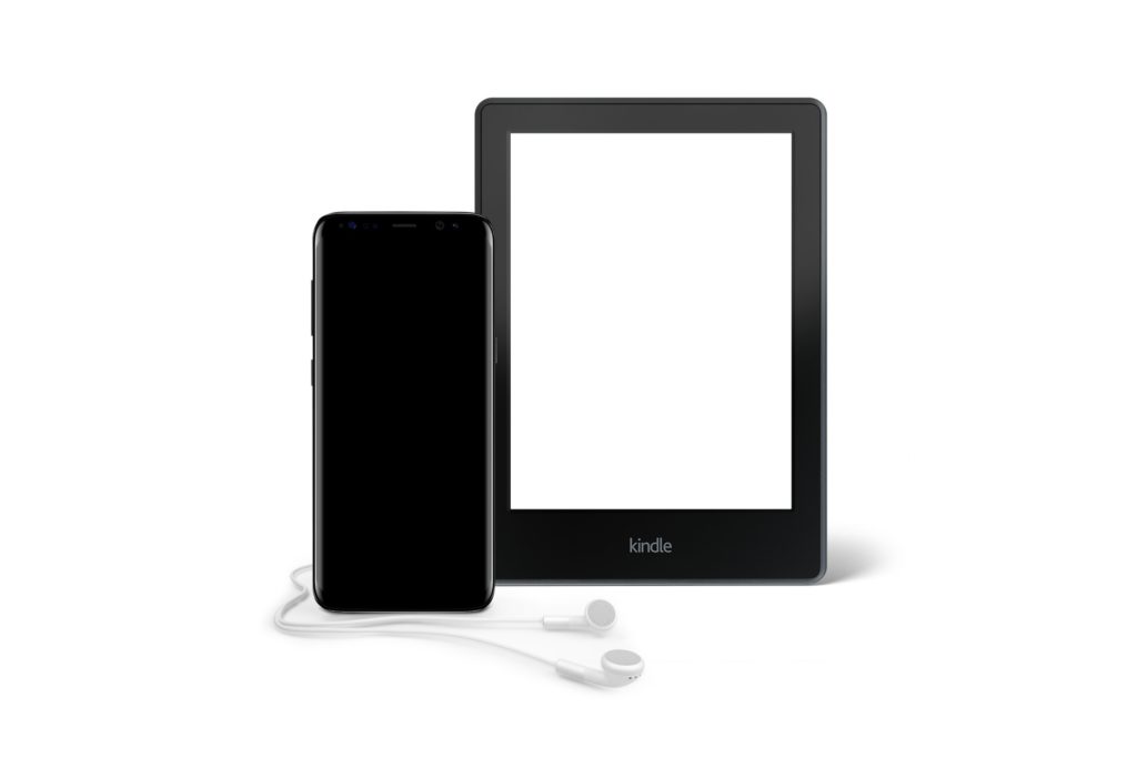 android phone with headphones and a tablet on a light background