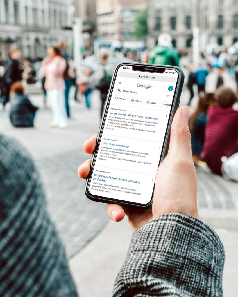 man holding smartphone outdoors with google search results on screen