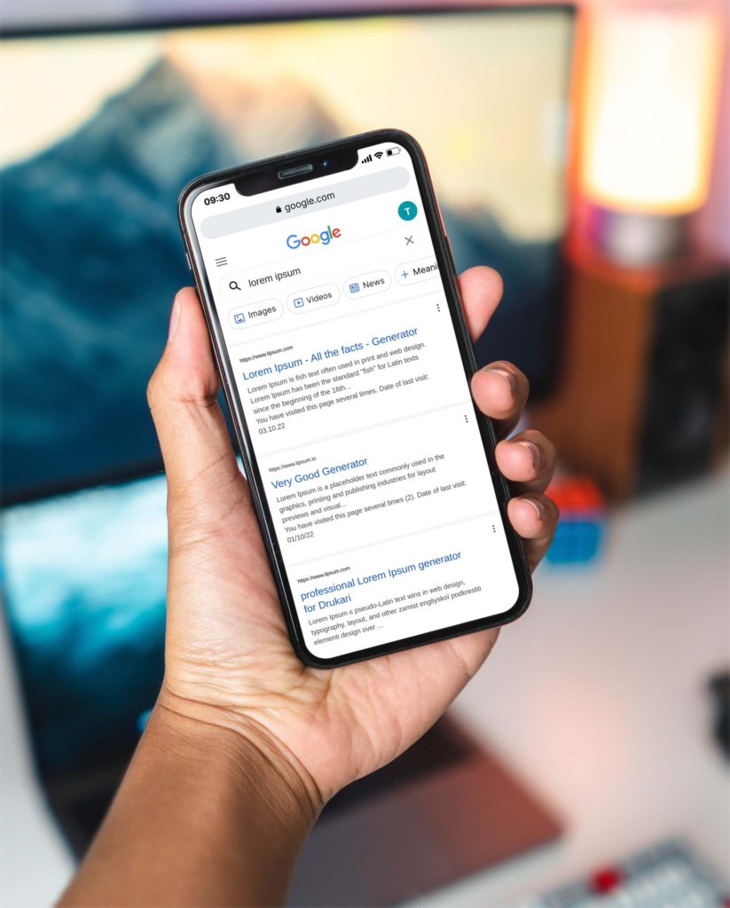 man holding iphone indoors and showing google search results on screen
